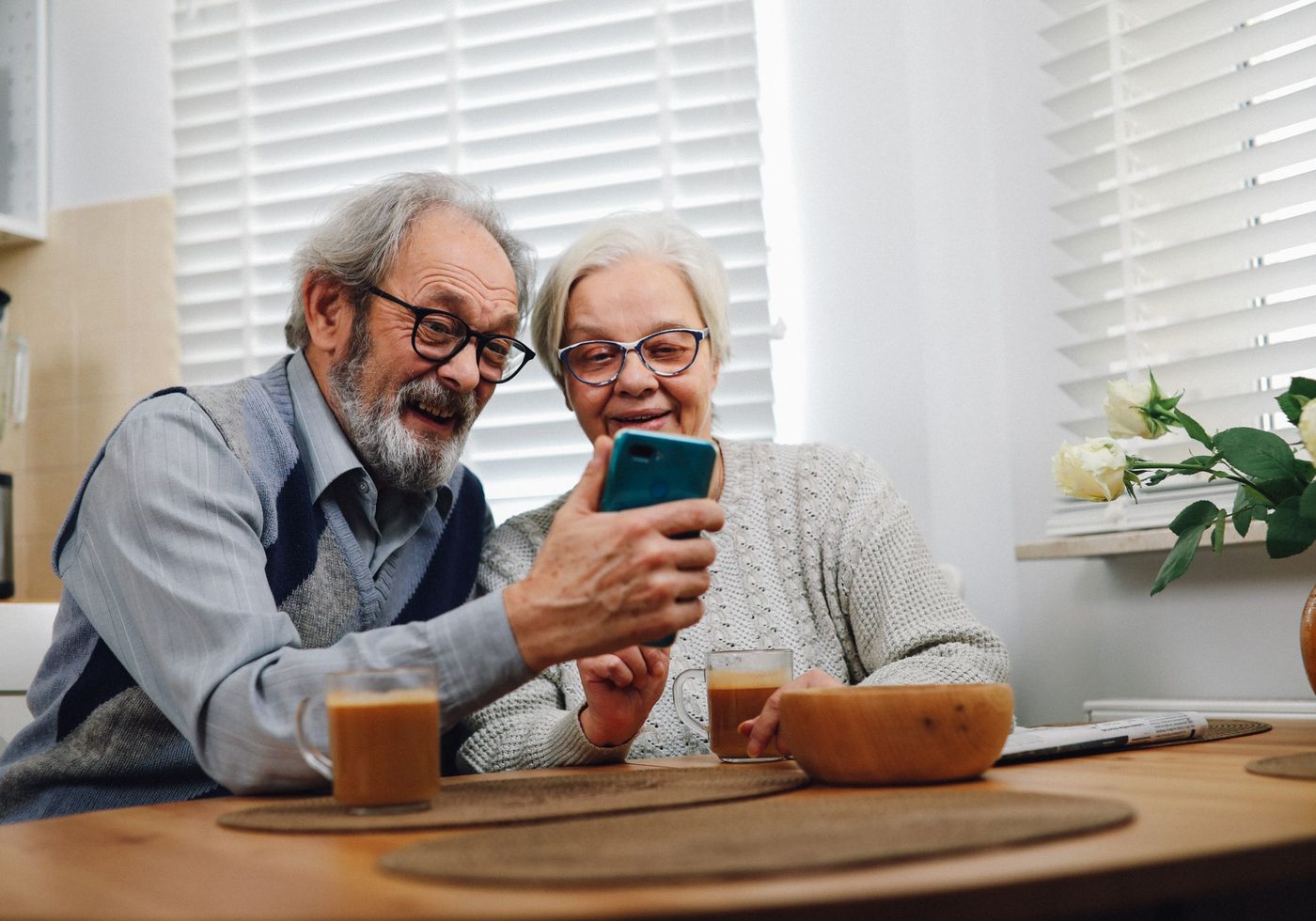 A couple reading on a phone at home