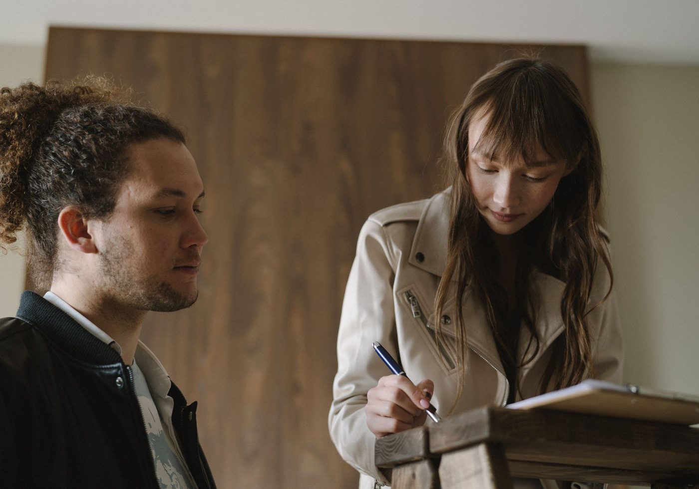A couple signing paperwork at home